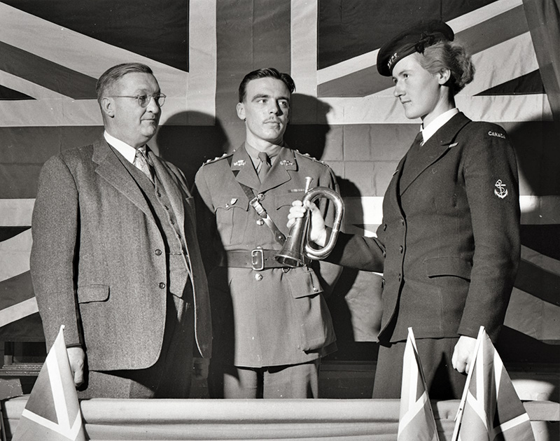 Karl Homuth introduced Capt. G. E. Jackson and Leading Wren Purvey who assisted at the opening of the Seventh Victory Loan Campaign.